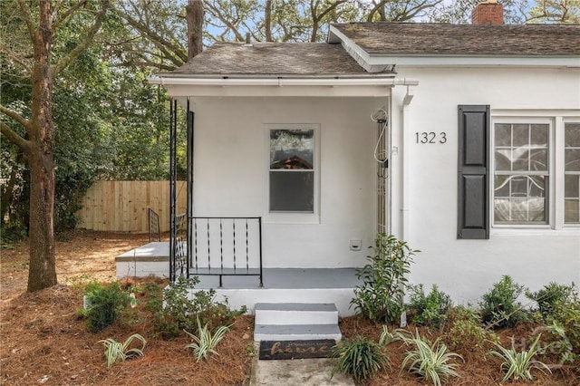 1321/1323 E 55th St, Savannah, GA 31404 - property entrance with stucco siding, a chimney, and a shingled roof