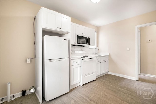 1321/1323 E 55th St, Savannah, GA 31404 - kitchen featuring white appliances, light wood-type flooring, decorative backsplash, white cabinets, and light countertops