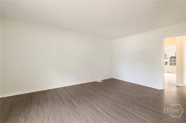 1321/1323 E 55th St, Savannah, GA 31404 - spare room with dark wood-type flooring and baseboards