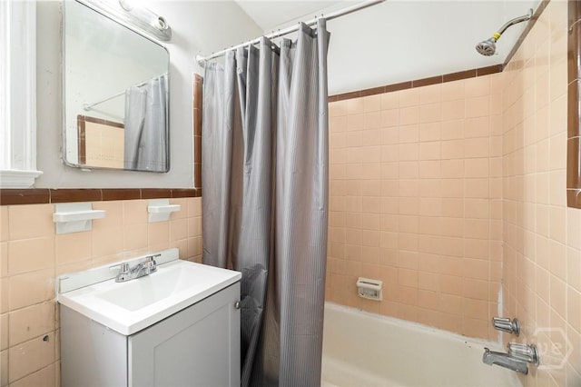 1321/1323 E 55th St, Savannah, GA 31404 - bathroom featuring shower / bathtub combination with curtain, vanity, and tile walls
