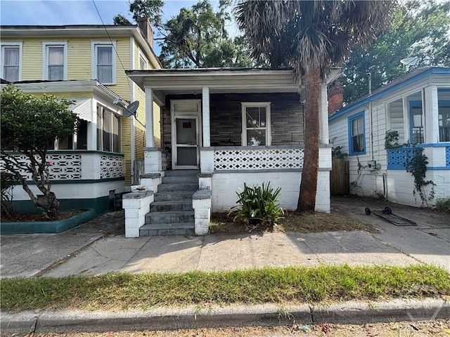 710 W 38th St, Savannah, GA 31415 - view of front of home with covered porch and a chimney