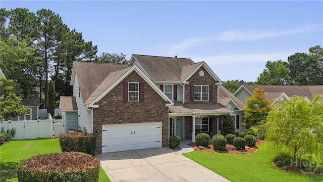5 Olde Gate Ct, Pooler, GA 31322 - traditional home featuring stone siding, concrete driveway, a gate, an attached garage, and roof with shingles