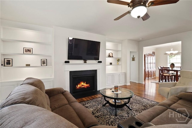 5 Olde Gate Ct, Pooler, GA 31322 - living room with built in features, wood finished floors, ceiling fan, and a fireplace with flush hearth