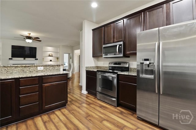 5 Olde Gate Ct, Pooler, GA 31322 - kitchen with appliances with stainless steel finishes, dark brown cabinets, light stone counters, light wood-style floors, and ceiling fan
