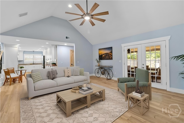 115 Coquena Cir E, Savannah, GA 31410 - living room featuring a ceiling fan, french doors, high vaulted ceiling, and light wood-style floors