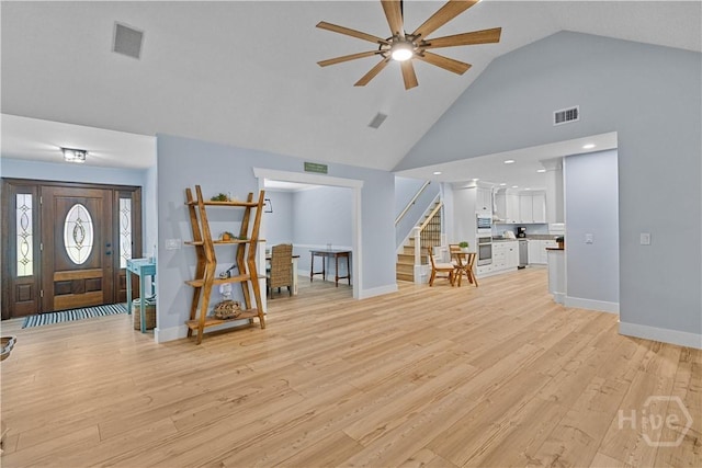 115 Coquena Cir E, Savannah, GA 31410 - living room featuring stairway, a ceiling fan, light wood-type flooring, and high vaulted ceiling