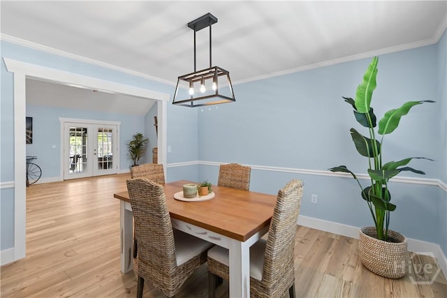 115 Coquena Cir E, Savannah, GA 31410 - dining room with french doors, light wood finished floors, a chandelier, and crown molding