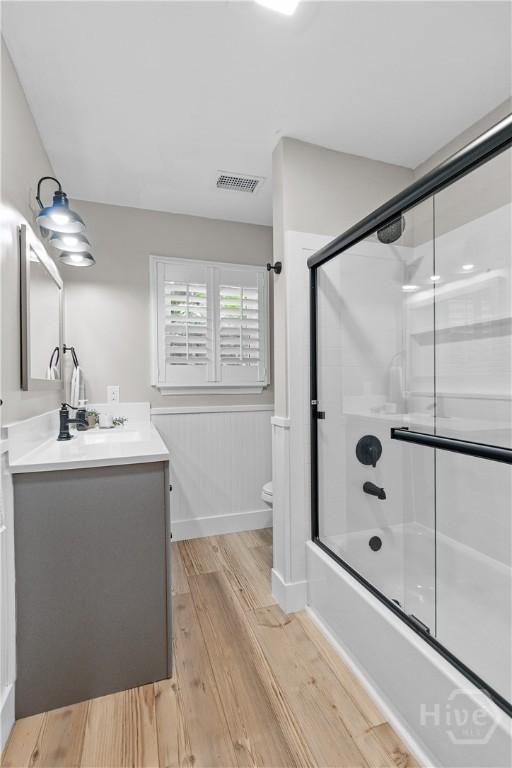 115 Coquena Cir E, Savannah, GA 31410 - full bath with vanity, wood finished floors, and bath / shower combo with glass door