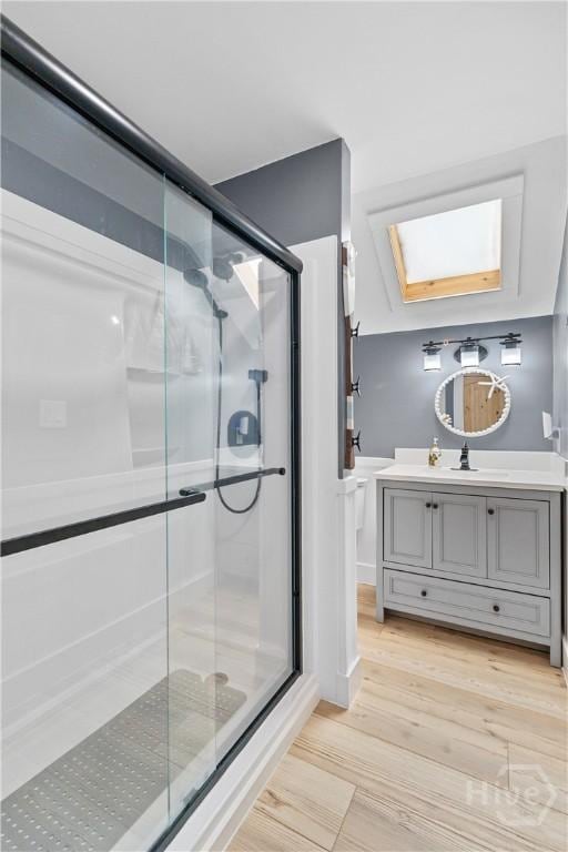 115 Coquena Cir E, Savannah, GA 31410 - bathroom with a skylight, vanity, wood finished floors, and a shower stall