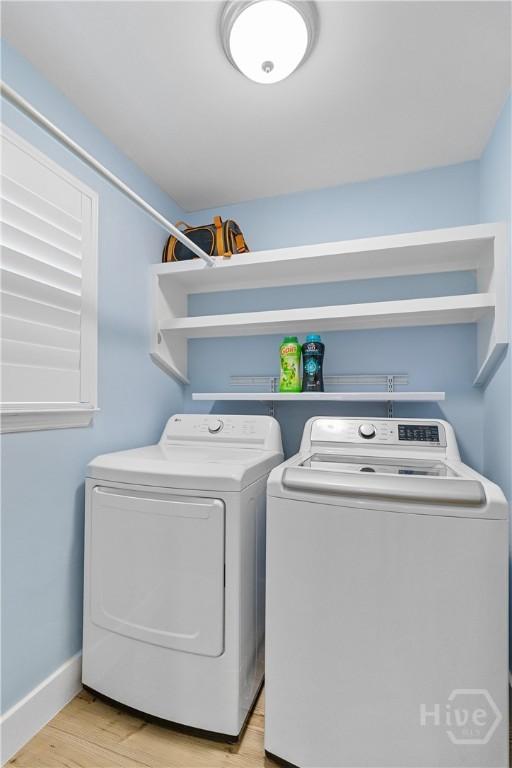 115 Coquena Cir E, Savannah, GA 31410 - laundry area featuring washing machine and clothes dryer and light wood-style flooring