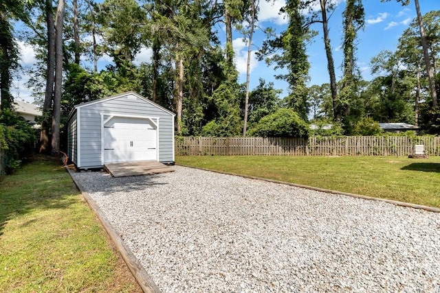 115 Coquena Cir E, Savannah, GA 31410 - view of yard with driveway, a detached garage, and an outdoor structure