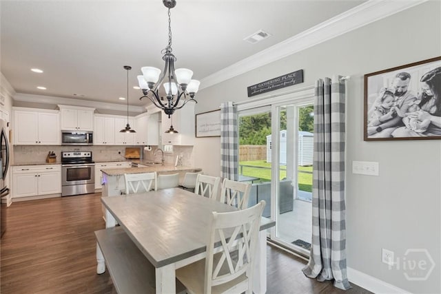 105 Summer Station Dr, Guyton, GA 31312 - dining space with a chandelier, crown molding, dark wood-style floors, and recessed lighting