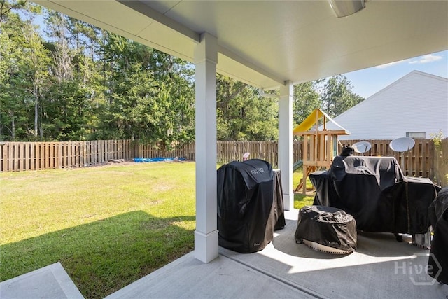 105 Summer Station Dr, Guyton, GA 31312 - fenced backyard with a grill, a playground, and a patio area