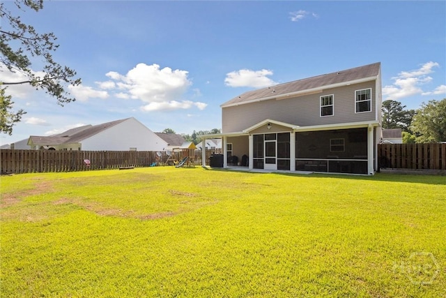 105 Summer Station Dr, Guyton, GA 31312 - rear view of house with a sunroom, a fenced backyard, and a playground