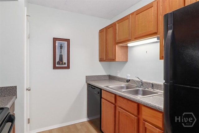401 N Cromwell Rd Unit Q2, Savannah, GA 31410 - kitchen with black appliances, light wood finished floors, and brown cabinetry