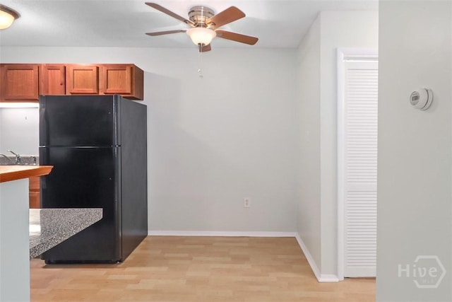 401 N Cromwell Rd Unit Q2, Savannah, GA 31410 - kitchen with freestanding refrigerator, ceiling fan, light wood-style flooring, and brown cabinets