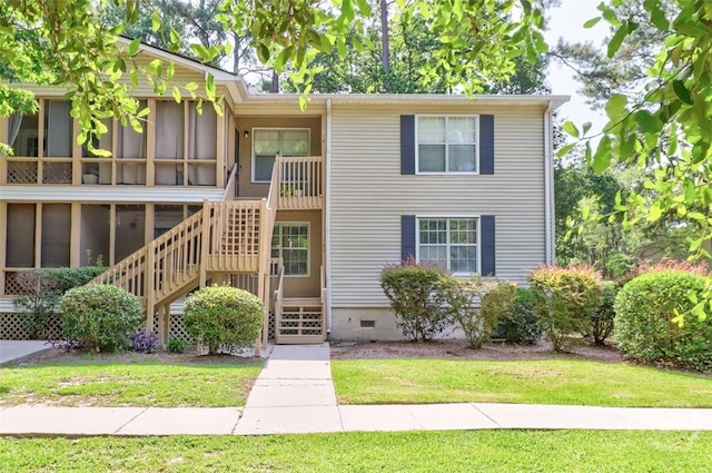 401 N Cromwell Rd Unit Q2, Savannah, GA 31410 - view of front facade featuring crawl space, stairway, a front yard, and a sunroom