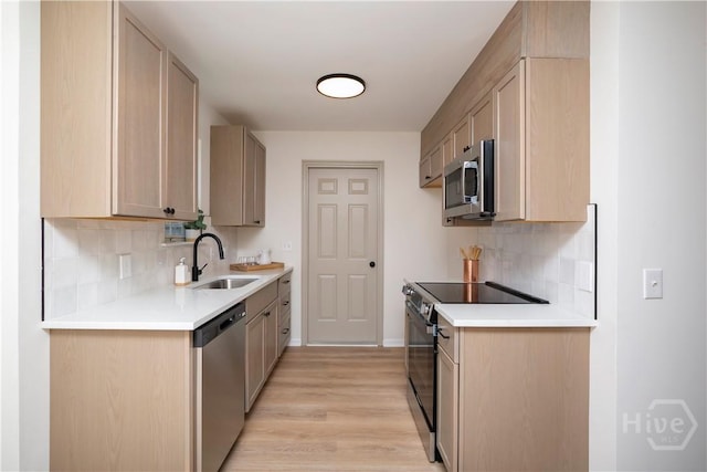 7231 Grant St, Savannah, GA 31406 - kitchen with appliances with stainless steel finishes, light wood finished floors, decorative backsplash, and light countertops