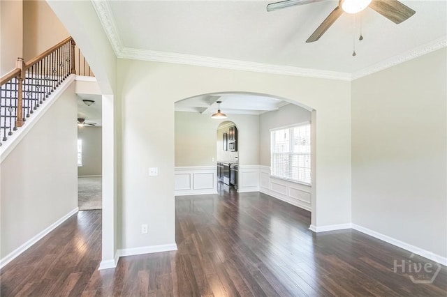 804 Barrington Dr, Hinesville, GA 31313 - spare room with a ceiling fan, dark wood-style flooring, arched walkways, ornamental molding, and stairs