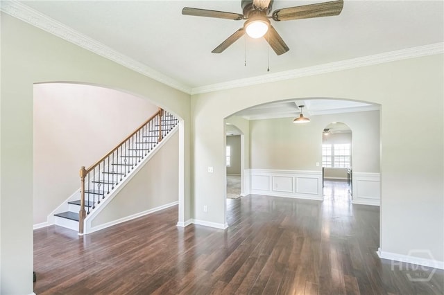 804 Barrington Dr, Hinesville, GA 31313 - empty room featuring dark wood-style flooring, ceiling fan, crown molding, arched walkways, and stairway