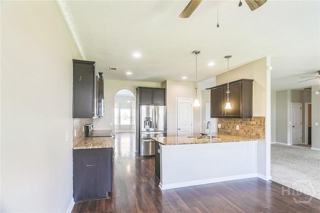804 Barrington Dr, Hinesville, GA 31313 - kitchen with ceiling fan, stainless steel fridge with ice dispenser, a peninsula, arched walkways, and light stone countertops