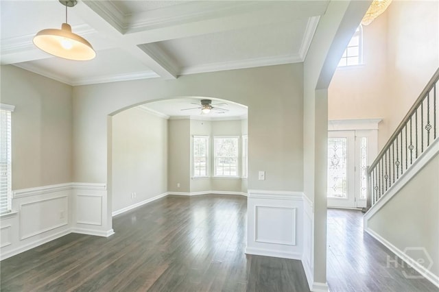 804 Barrington Dr, Hinesville, GA 31313 - unfurnished room with arched walkways, a ceiling fan, dark wood-type flooring, beam ceiling, and stairs
