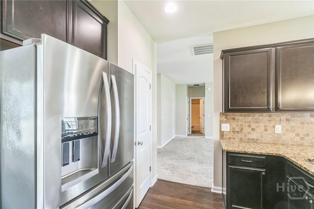 804 Barrington Dr, Hinesville, GA 31313 - kitchen with stainless steel fridge with ice dispenser, dark brown cabinets, dark wood-style floors, light stone counters, and decorative backsplash