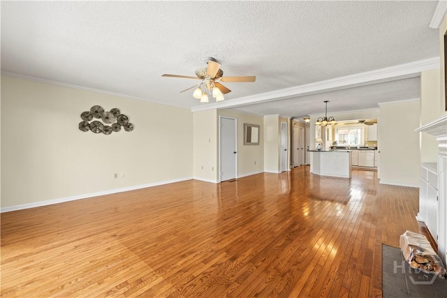 12502 Apache Ave Unit 18, Savannah, GA 31419 - unfurnished living room with ceiling fan, light wood finished floors, a textured ceiling, crown molding, and a chandelier