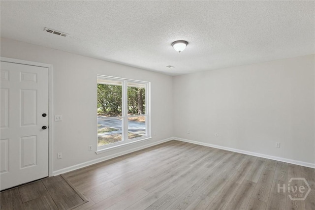 1021 Walnut Ct, Springfield, GA 31329 - unfurnished room with light wood-style floors and a textured ceiling