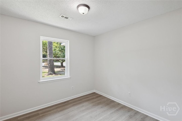 1021 Walnut Ct, Springfield, GA 31329 - spare room with light wood-type flooring and a textured ceiling