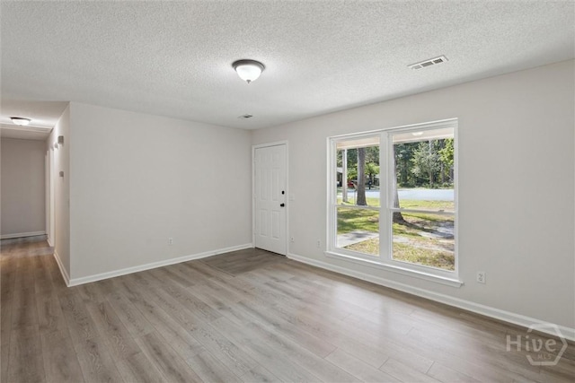 1021 Walnut Ct, Springfield, GA 31329 - unfurnished room with wood finished floors and a textured ceiling