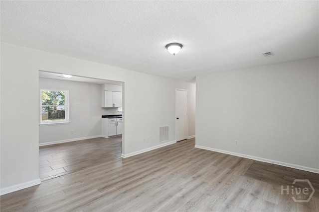 1021 Walnut Ct, Springfield, GA 31329 - unfurnished room featuring light wood-style floors and a textured ceiling