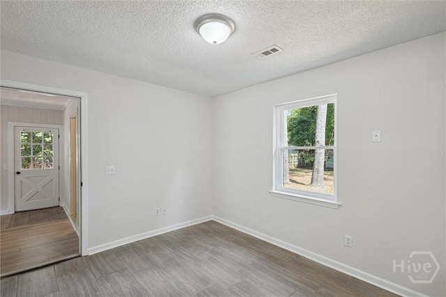 1021 Walnut Ct, Springfield, GA 31329 - empty room with a textured ceiling and wood finished floors