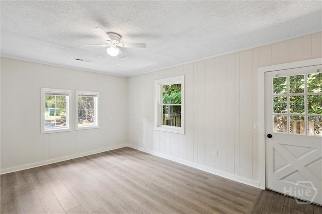 1021 Walnut Ct, Springfield, GA 31329 - unfurnished room with wood finished floors, a ceiling fan, and a textured ceiling