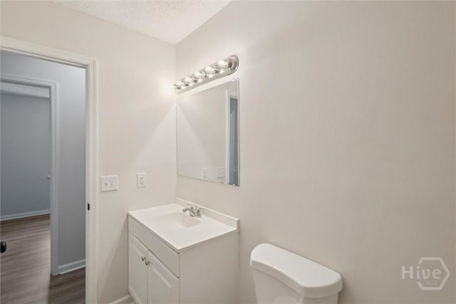 1021 Walnut Ct, Springfield, GA 31329 - bathroom with vanity, a textured ceiling, and wood finished floors