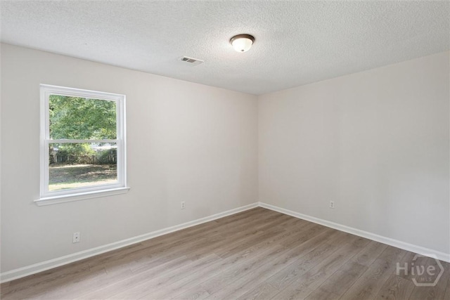 1021 Walnut Ct, Springfield, GA 31329 - empty room with wood finished floors and a textured ceiling