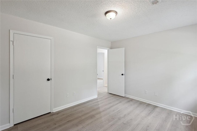 1021 Walnut Ct, Springfield, GA 31329 - unfurnished bedroom with wood finished floors and a textured ceiling