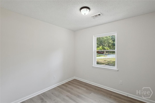 1021 Walnut Ct, Springfield, GA 31329 - spare room featuring wood finished floors and a textured ceiling