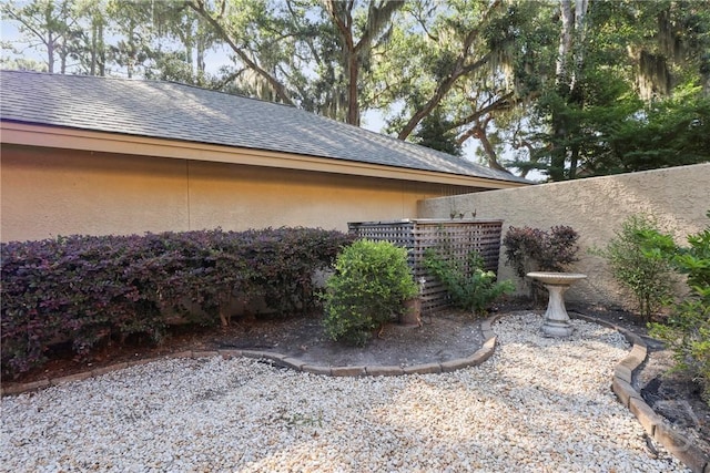 4 Tapestry Ln, Savannah, GA 31411 - view of side of home featuring stucco siding and roof with shingles
