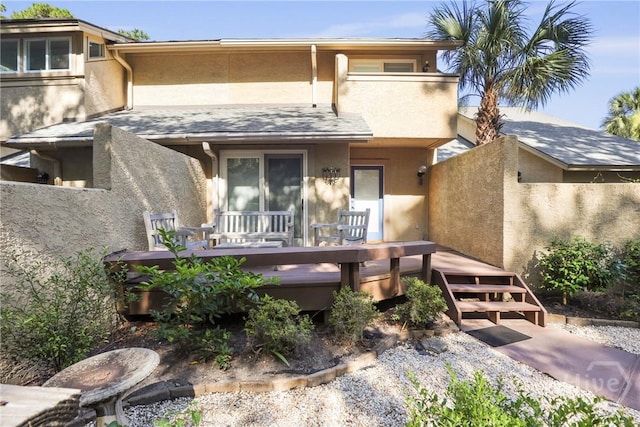 4 Tapestry Ln, Savannah, GA 31411 - back of property featuring stucco siding, a covered hot tub, and a deck