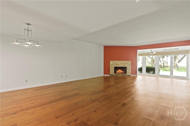 4 Tapestry Ln, Savannah, GA 31411 - unfurnished living room with wood finished floors, a fireplace, and ceiling fan