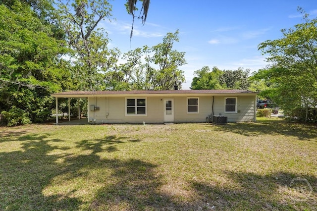 13 Hughes Ave, Savannah, GA 31406 - rear view of house with a lawn and an attached carport