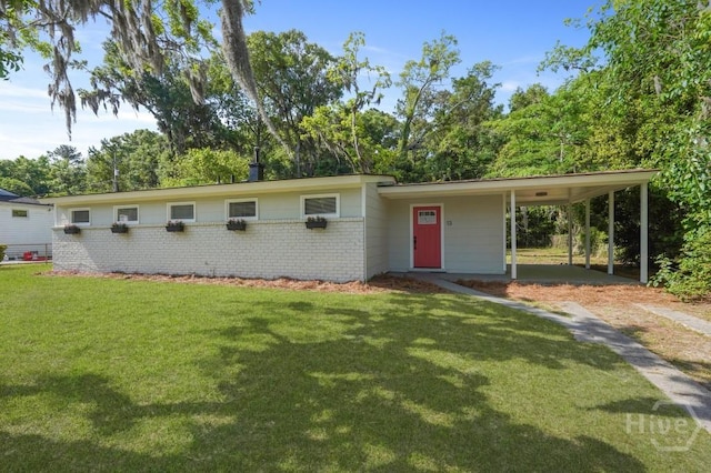 13 Hughes Ave, Savannah, GA 31406 - view of front of home with a front yard, a carport, brick siding, and driveway