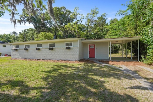 13 Hughes Ave, Savannah, GA 31406 - view of front of home with a front yard, brick siding, an attached carport, and driveway