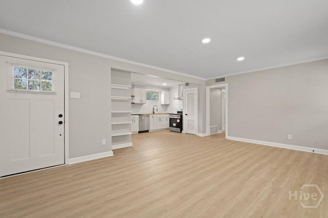 13 Hughes Ave, Savannah, GA 31406 - unfurnished living room featuring ornamental molding, light wood-type flooring, and recessed lighting