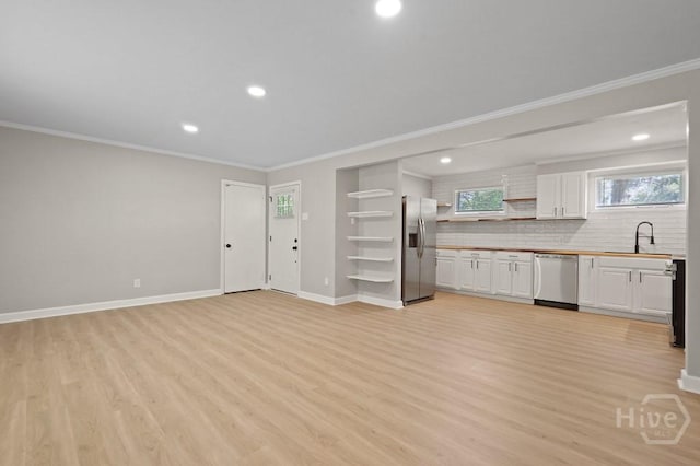 13 Hughes Ave, Savannah, GA 31406 - kitchen featuring appliances with stainless steel finishes, light wood-style floors, crown molding, white cabinets, and recessed lighting