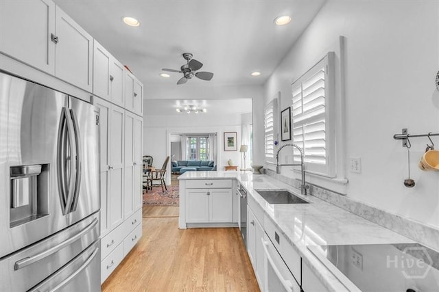 1226 E 50th St, Savannah, GA 31404 - kitchen with stainless steel appliances, a ceiling fan, white cabinetry, recessed lighting, and light stone countertops