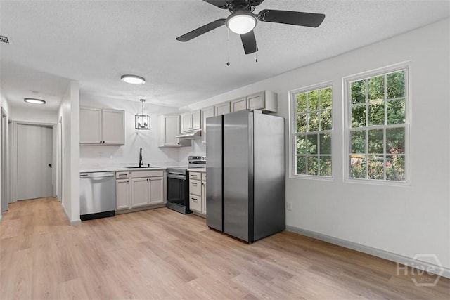109 E Tietgen St, Pooler, GA 31322 - kitchen featuring stainless steel appliances, light countertops, light wood-type flooring, a textured ceiling, and a ceiling fan