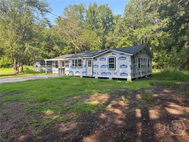 156 Diamond Ln, Midway, GA 31320 - view of front of house featuring a front yard and a forest view