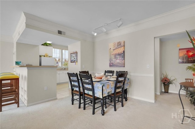 1312 Whitemarsh Way, Savannah, GA 31410 - dining area featuring light carpet, track lighting, and ornamental molding